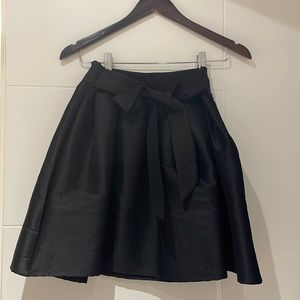 Black pleaded skirt with stretchy waistband and zipper on the side!